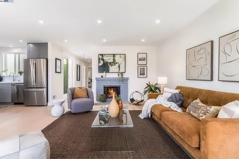 a living room with furniture fireplace and a window