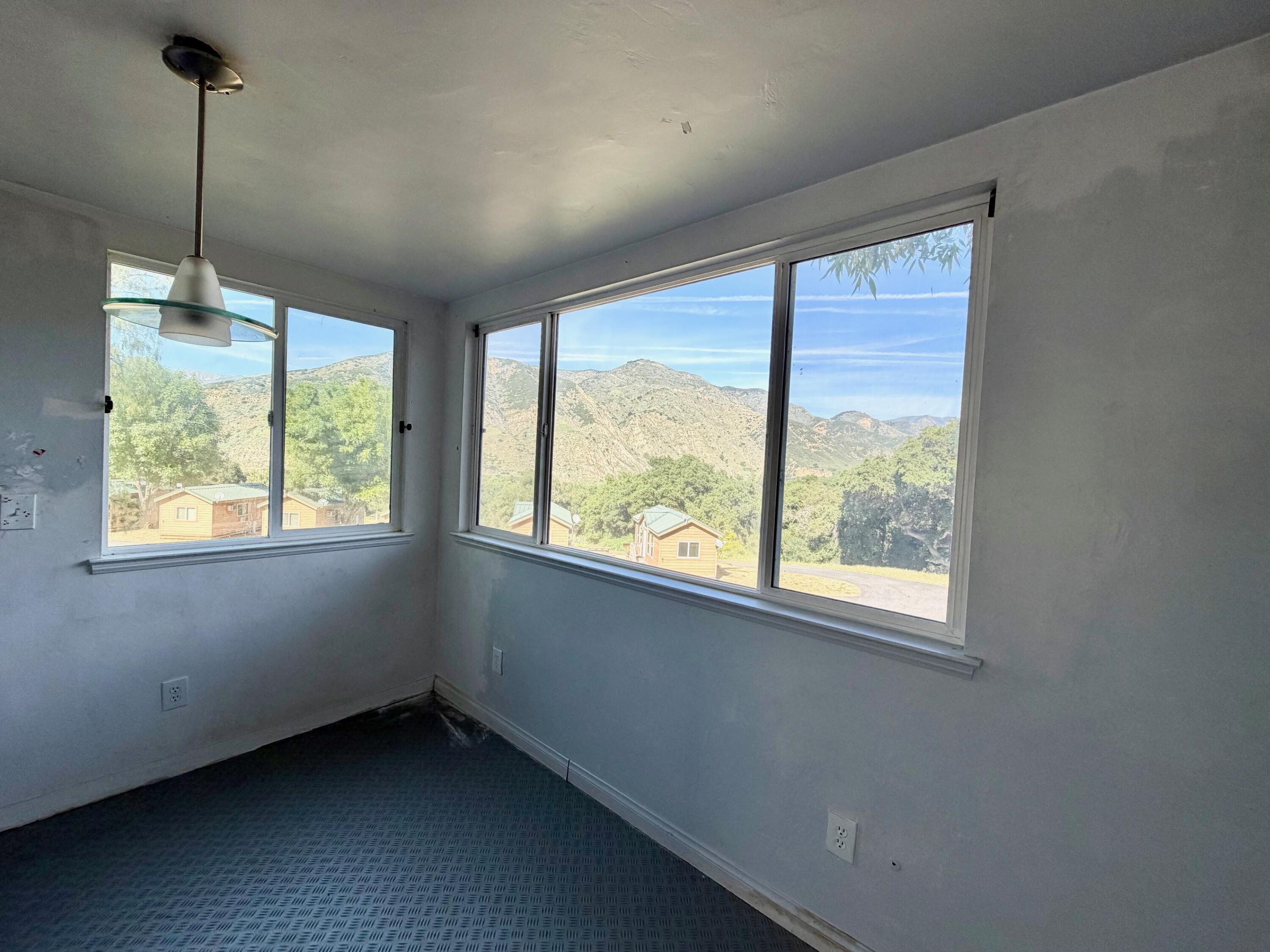 3750 Paradise Road, Unit 97 Santa Barbara, CA 93105 - Photo 5 of 17 a view of an empty room with windows and a chandelier