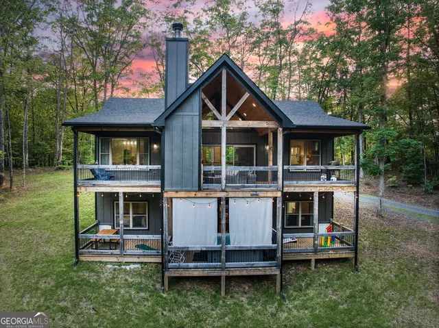 a living room with fireplace furniture and a large window