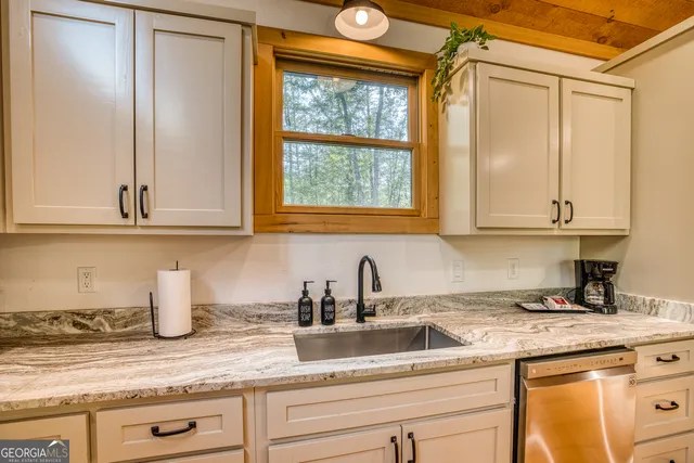 a view of a dining room with furniture a chandelier and wooden floor