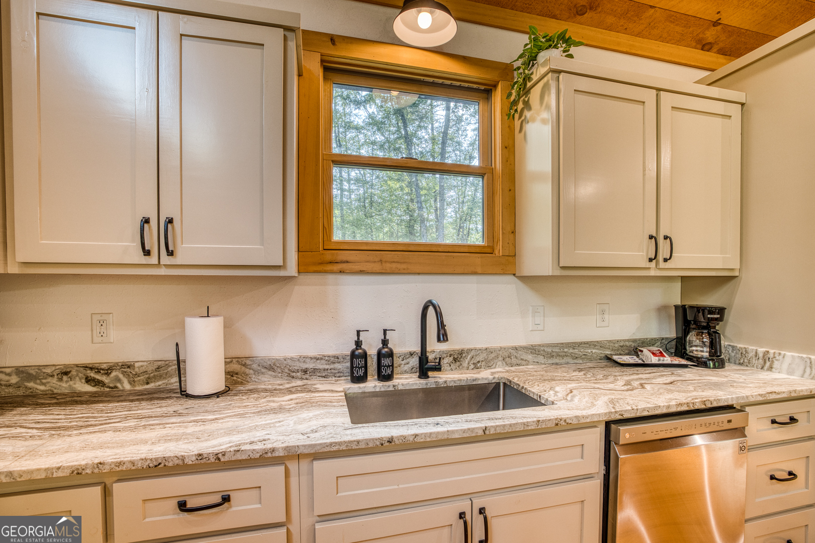 284 Lees Ride McCaysville, GA 30555 - Photo 11 of 104 a kitchen with stainless steel appliances granite countertop white cabinets and a window