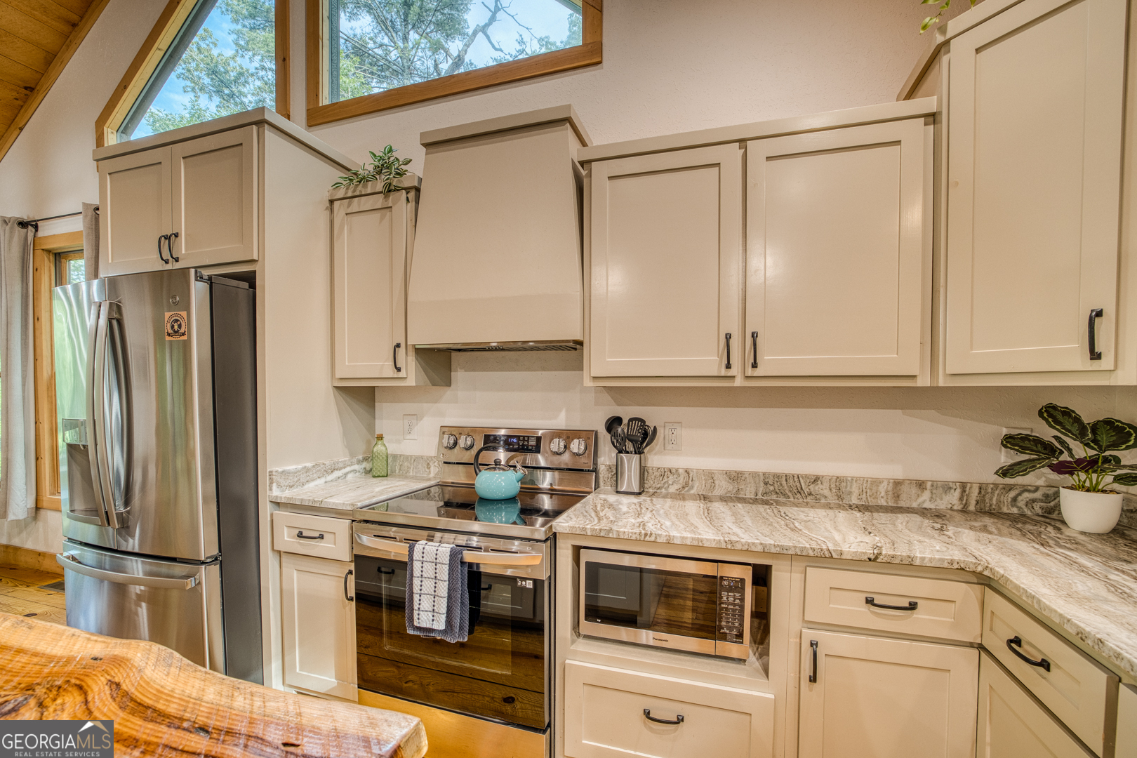 284 Lees Ride McCaysville, GA 30555 - Photo 12 of 104 a kitchen with stainless steel appliances a refrigerator sink and cabinets