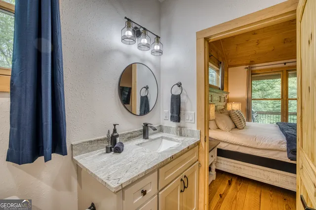 a bedroom with a large bed and a chandelier