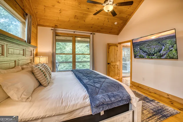 a bedroom with a large bed and a window