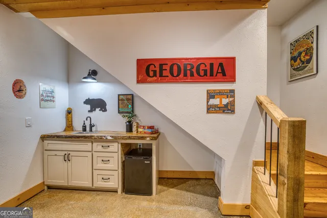 a bedroom with a bed and a painting on the wall