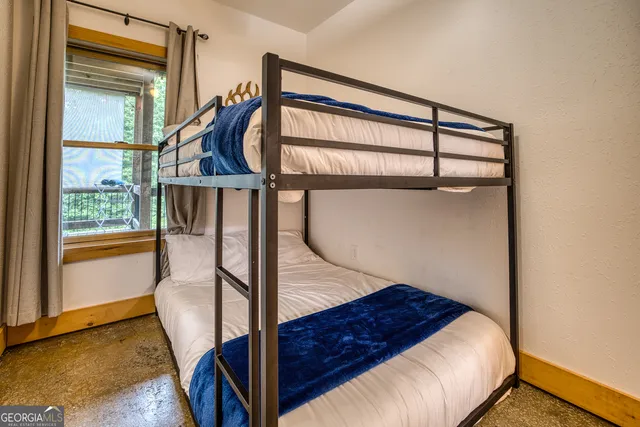 a living room with furniture a fireplace and a large window