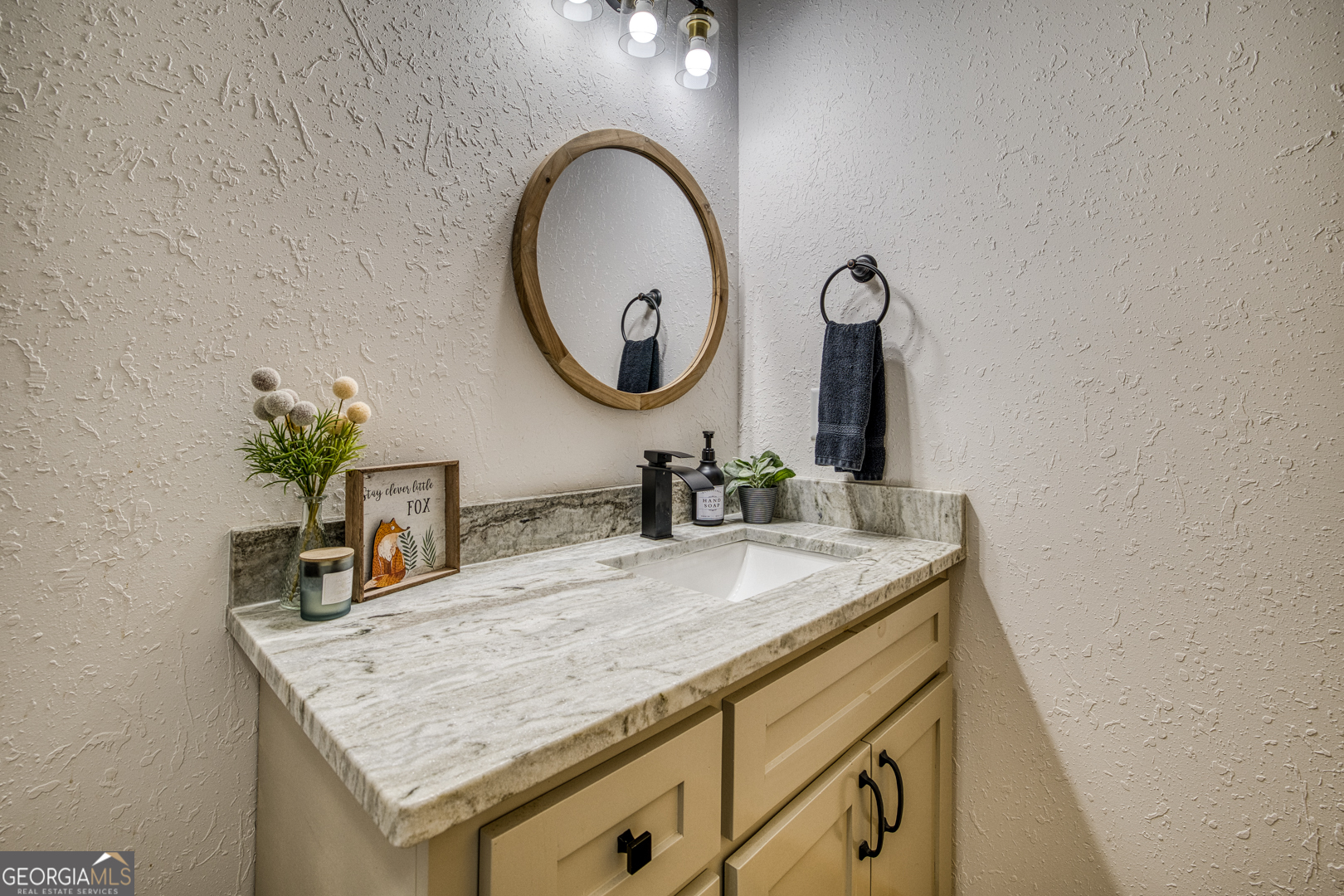 284 Lees Ride McCaysville, GA 30555 - Photo 41 of 104 a bathroom with a granite countertop sink a mirror and vanity