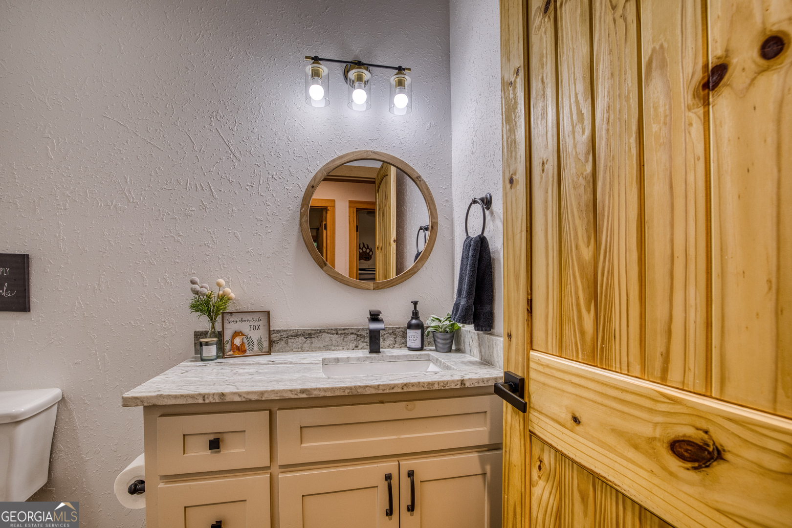 284 Lees Ride McCaysville, GA 30555 - Photo 44 of 104 a bathroom with a granite countertop sink and a mirror
