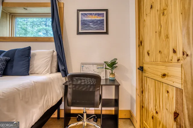 a view of a house with a yard and wooden fence