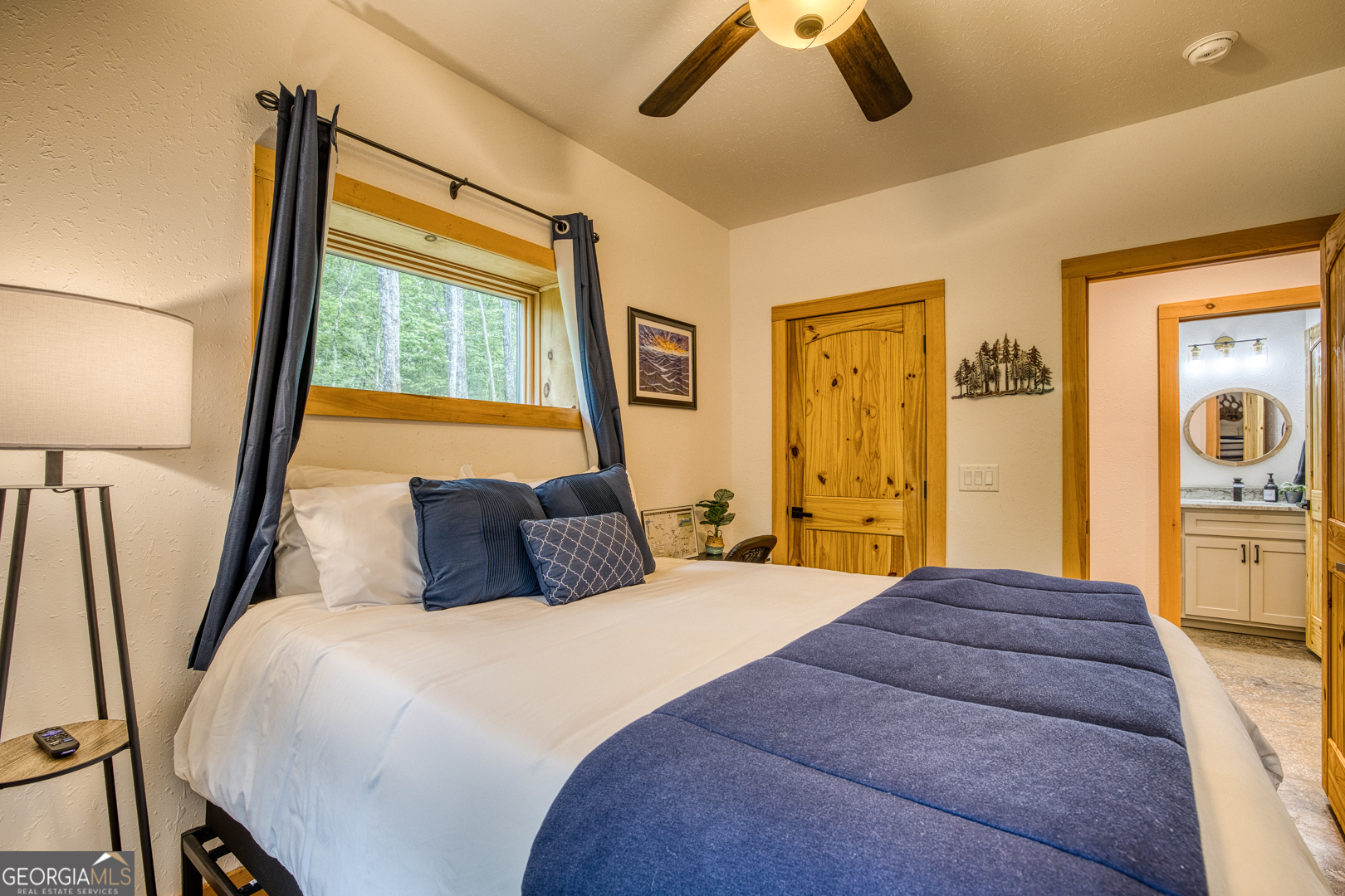284 Lees Ride McCaysville, GA 30555 - Photo 49 of 104 a bedroom with a large bed and a chandelier