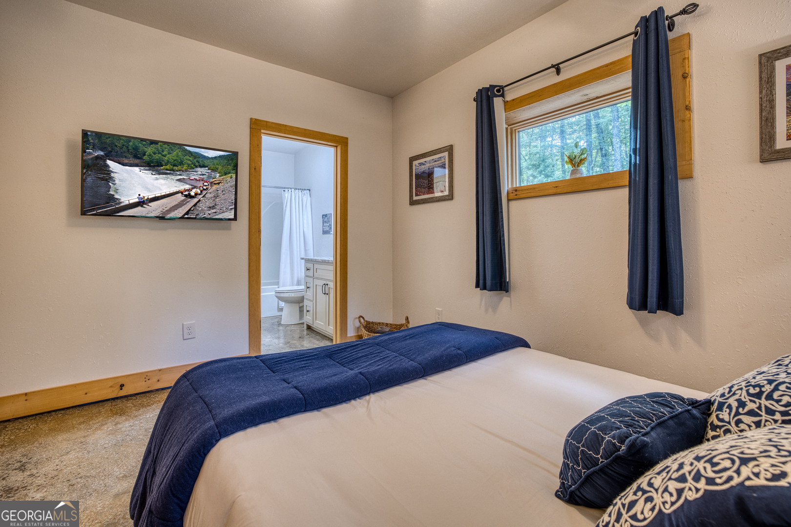 284 Lees Ride McCaysville, GA 30555 - Photo 54 of 104 a bedroom with a bed and a painting on the wall