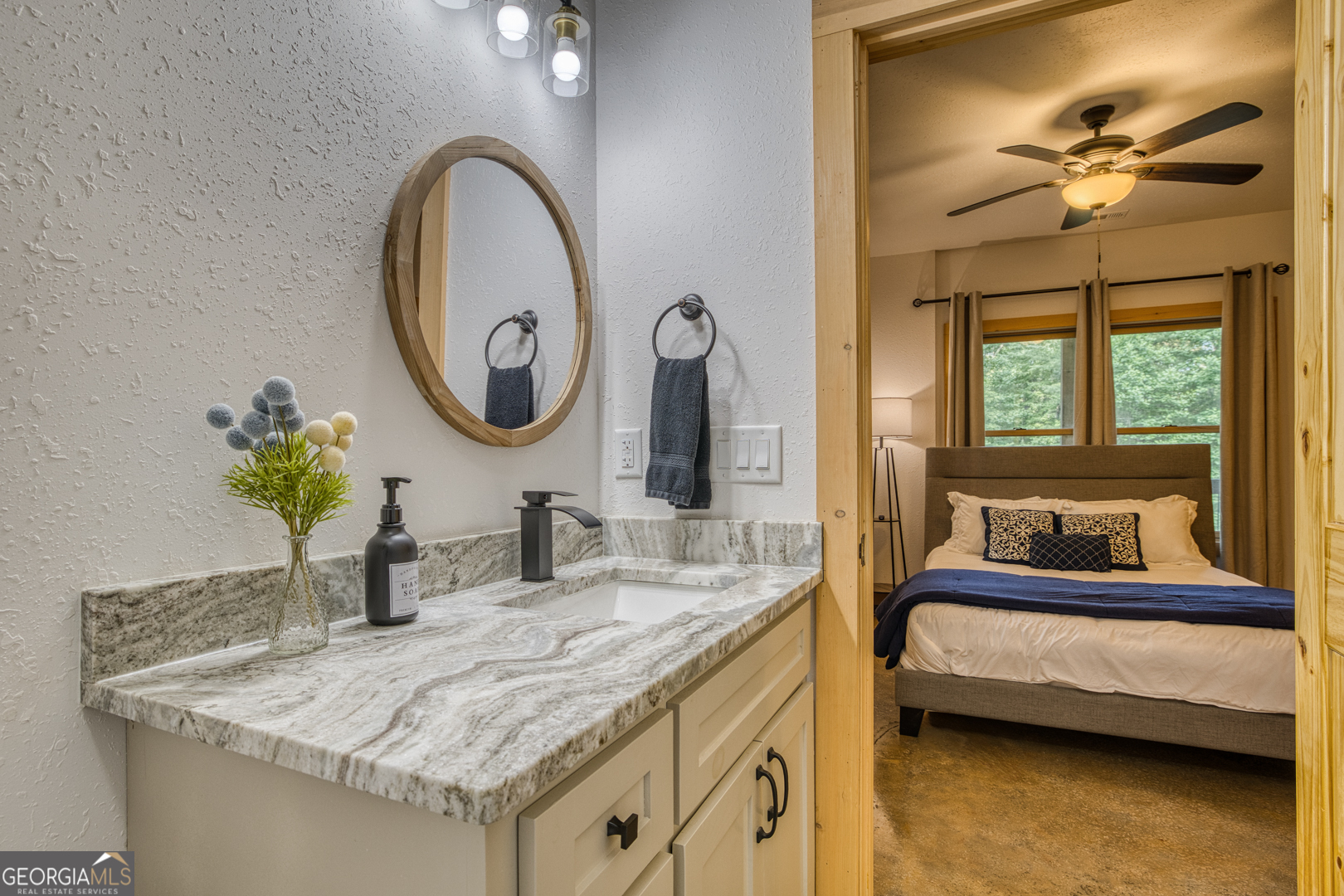 284 Lees Ride McCaysville, GA 30555 - Photo 56 of 104 a bathroom with a granite countertop sink and a mirror