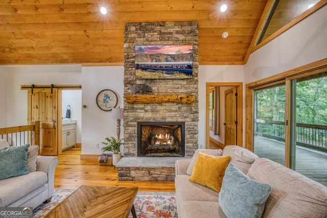 a kitchen with stainless steel appliances granite countertop white cabinets and a window