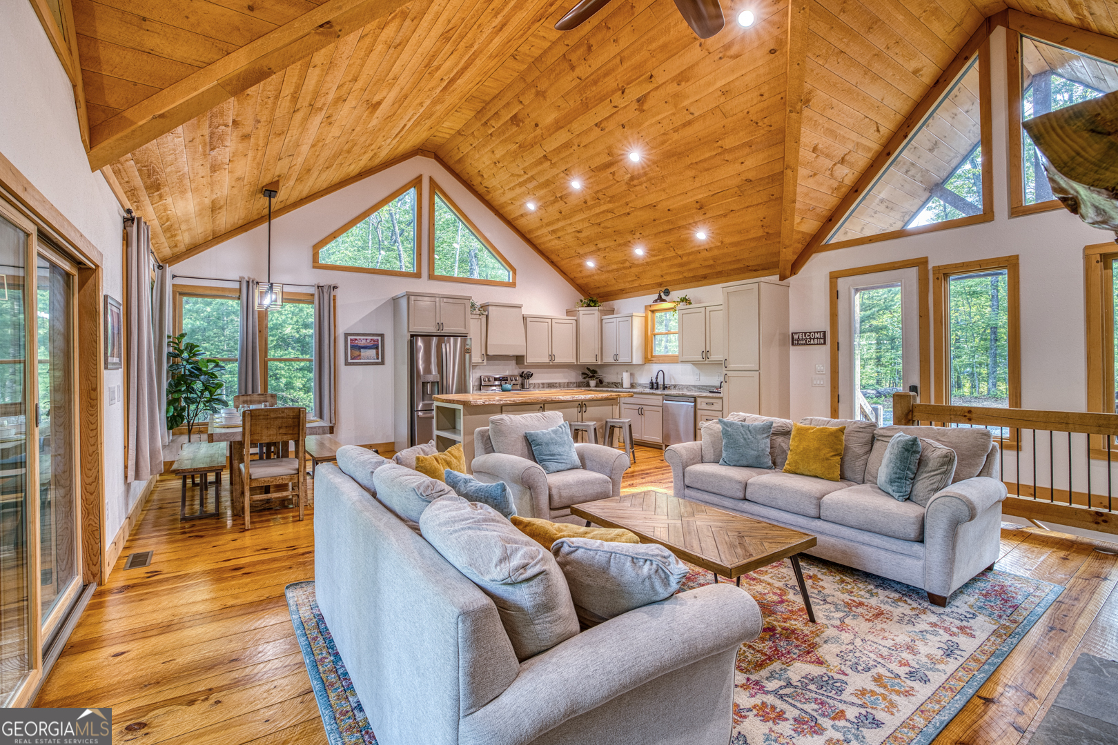 284 Lees Ride McCaysville, GA 30555 - Photo 8 of 104 a living room with furniture a large window and wooden floors