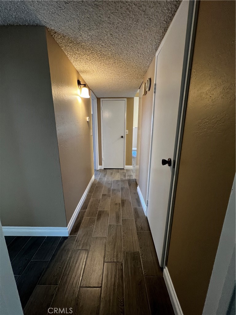 1744 Capri Avenue Mentone, CA 92359 - Photo 13 of 24 a view of a hallway with wooden floor and staircase