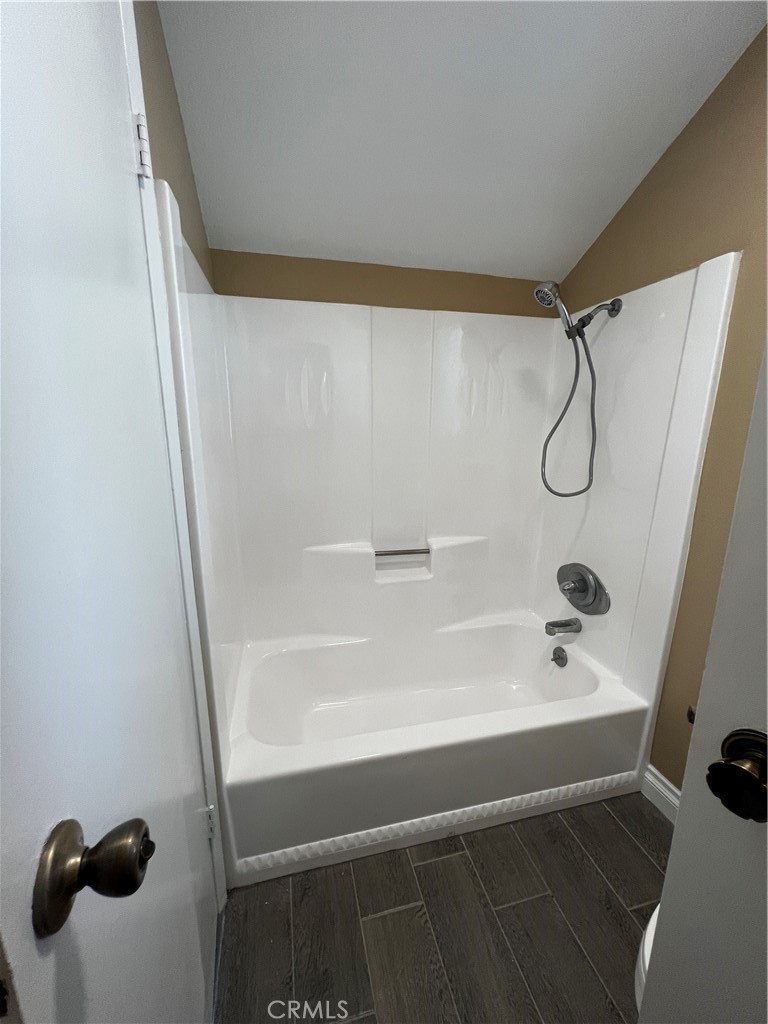 1744 Capri Avenue Mentone, CA 92359 - Photo 20 of 24 a bathroom with a shower and a bathtub