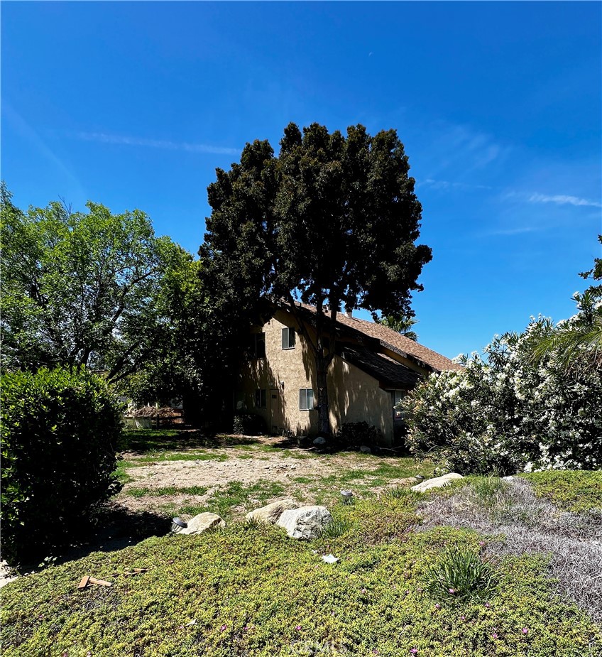 1744 Capri Avenue Mentone, CA 92359 - Photo 2 of 24 a view of a wooden house with a yard