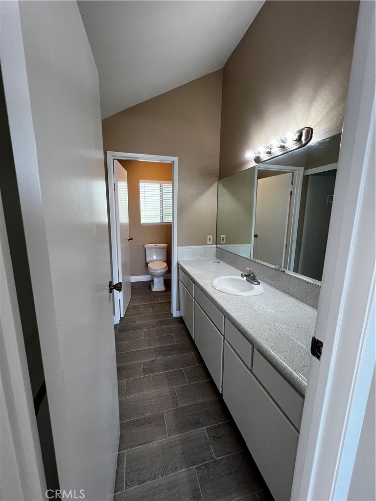 1744 Capri Avenue Mentone, CA 92359 - Photo 21 of 24 a bathroom with a double vanity sink and mirror