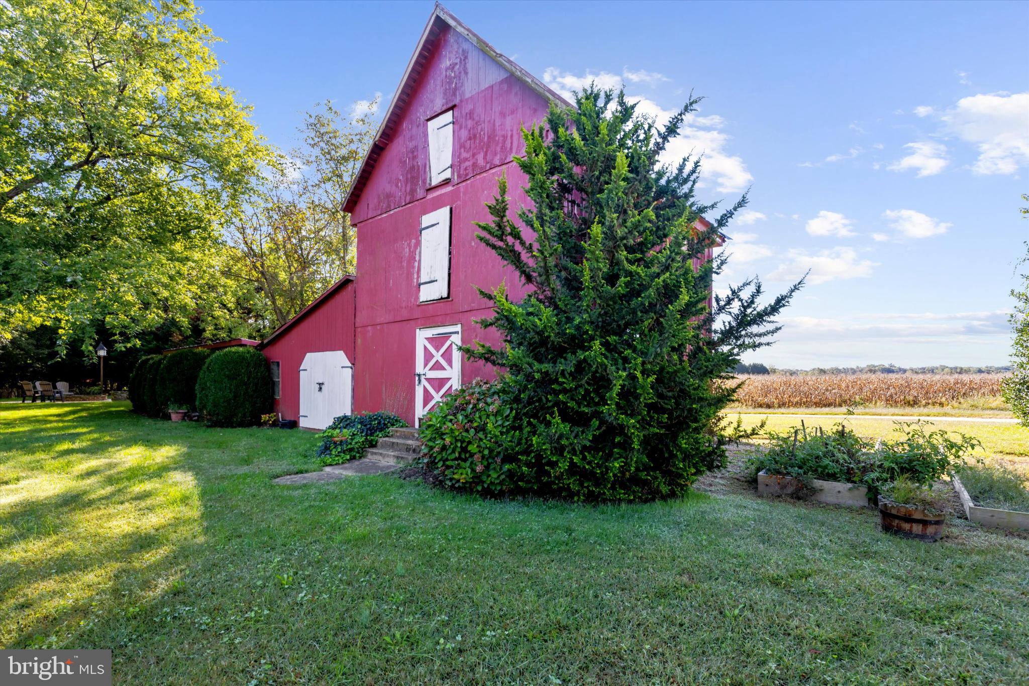 252 Granny Branch Road Church Hill, MD 21623 - Photo 61 of 75 Charming red barn amidst lush greenery.