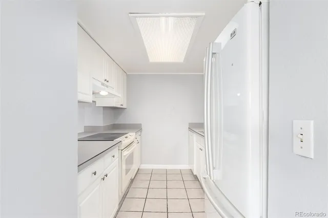 a kitchen with cabinets and a stove