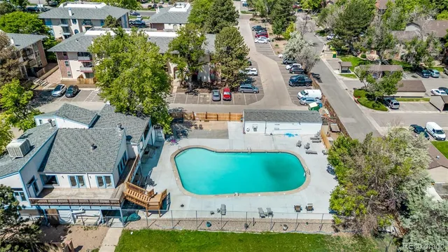 an aerial view of a house with a swimming pool outdoor seating yard and mountain view