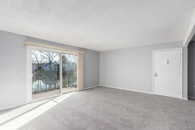 a view of an empty room with glass door
