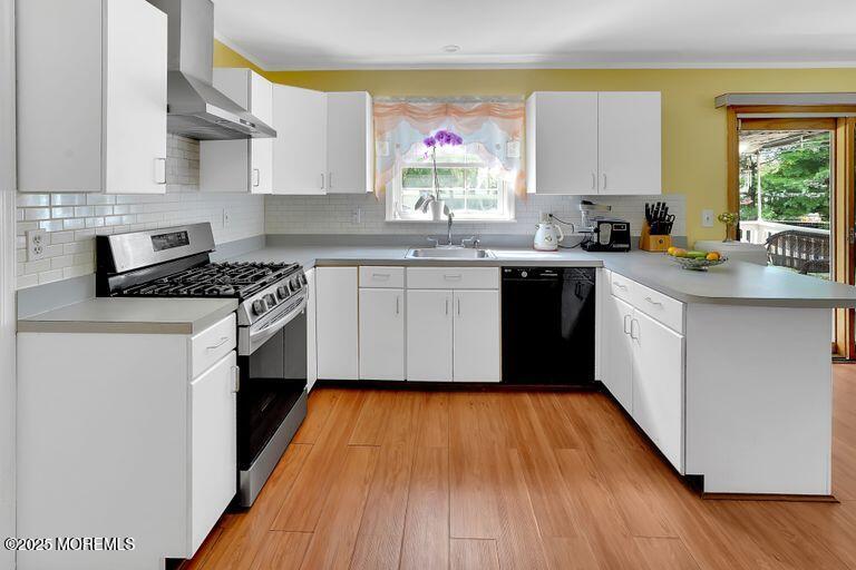 389 Aldrich Road Howell, NJ 07731 - Photo 11 of 55 a kitchen with wooden floors appliances a sink and cabinets