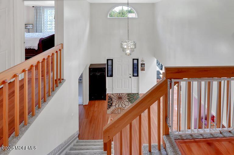 389 Aldrich Road Howell, NJ 07731 - Photo 19 of 55 a view of staircase with railing and a chandelier