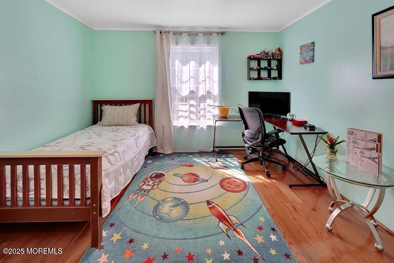 389 Aldrich Road Howell, NJ 07731 - Photo 29 of 55 a bedroom with a bed and wooden floor