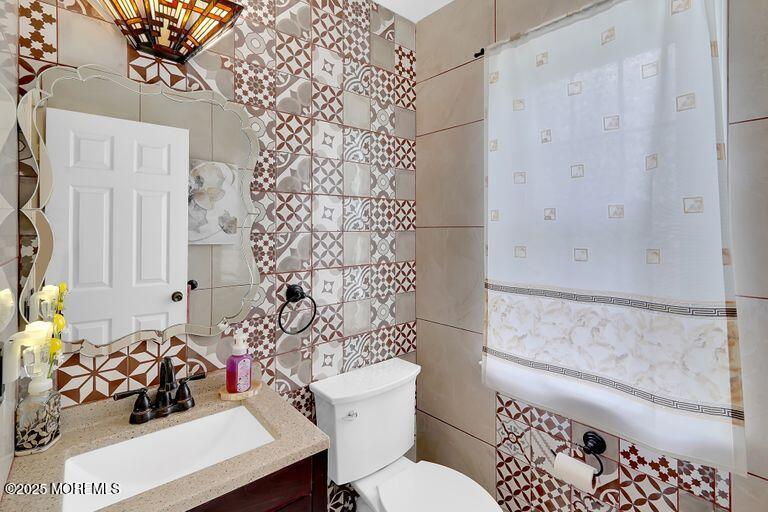 389 Aldrich Road Howell, NJ 07731 - Photo 33 of 55 a bathroom with a sink a toilet and shower curtain