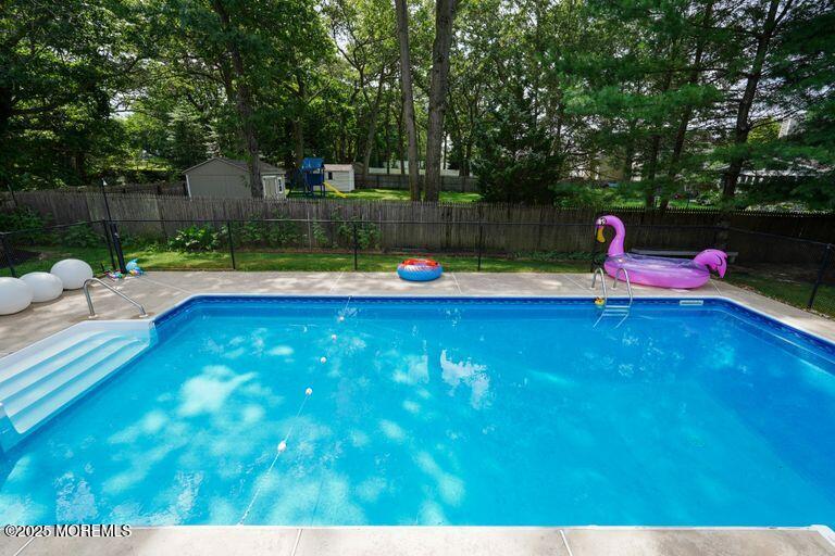 389 Aldrich Road Howell, NJ 07731 - Photo 47 of 55 a view of a swimming pool with a yard