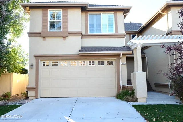 a front view of a house with a garage