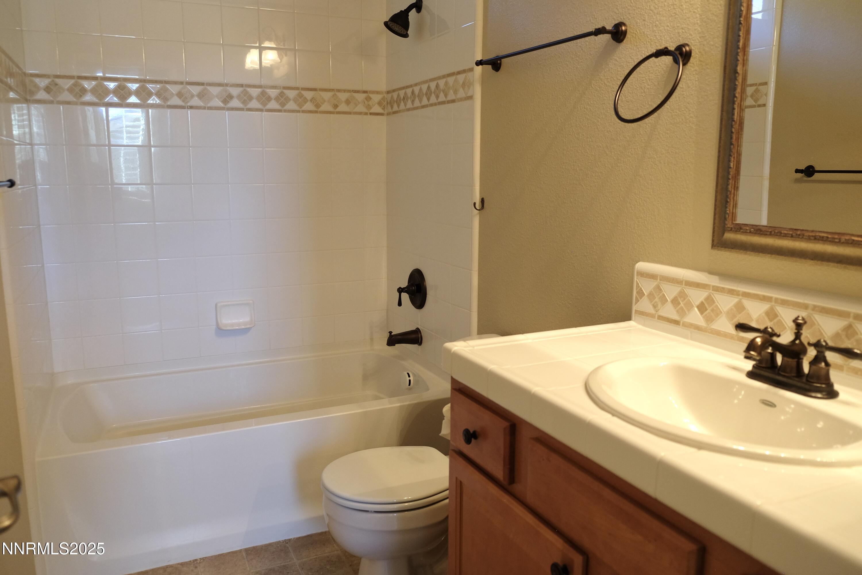 11039 Lamour Lane Reno, NV 89521 - Photo 12 of 25 a bathroom with a sink a toilet and shower