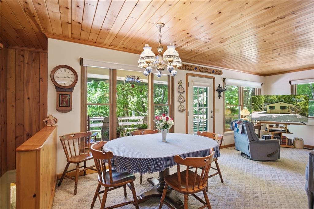 46 Spartan Lane Rabun Gap, GA 30568 - Photo 20 of 89 a view of a dining room with furniture large windows and wooden floor
