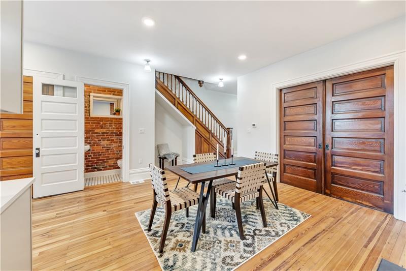 232 South Mathilda Street Friendship Park, PA 15224 - Photo 7 of 25 Showing off the pocket doors that lead to the living room. Check out the exposed brick in the powder room!