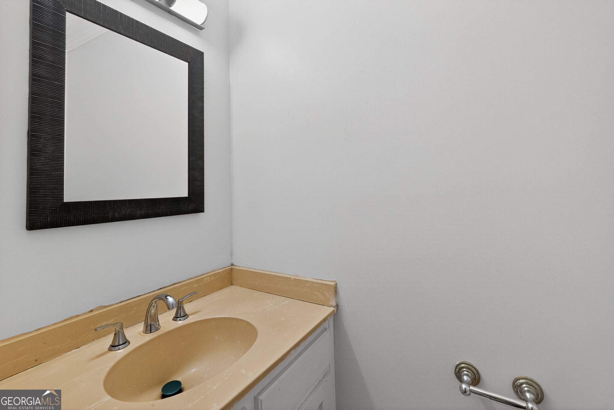 898 Chippendale Lane Norcross, GA 30093 - Photo 16 of 18 a bathroom with a sink and a mirror