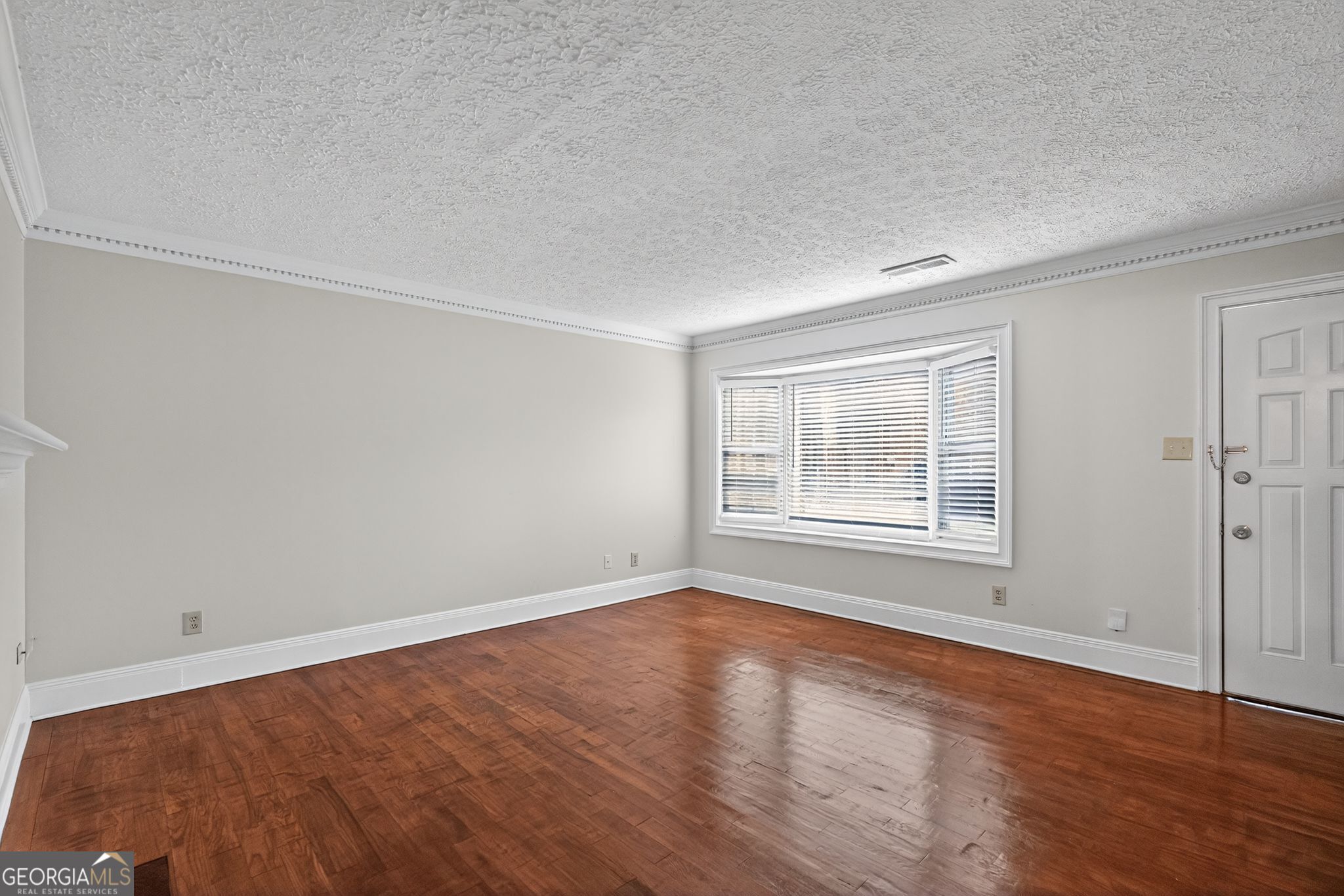 898 Chippendale Lane Norcross, GA 30093 - Photo 2 of 18 an empty room with wooden floor and windows