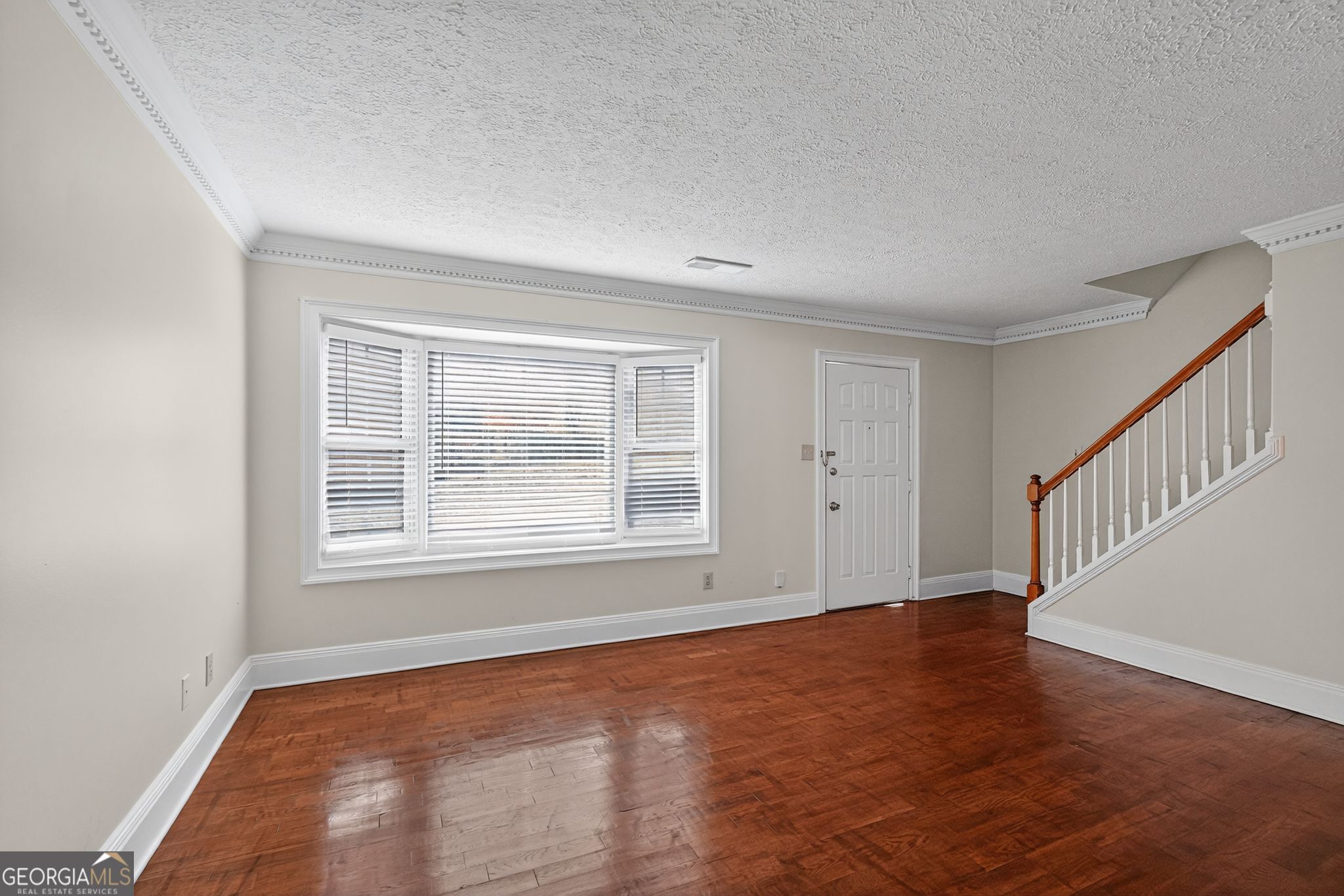 898 Chippendale Lane Norcross, GA 30093 - Photo 3 of 18 a view of an empty room with wooden floor and a window