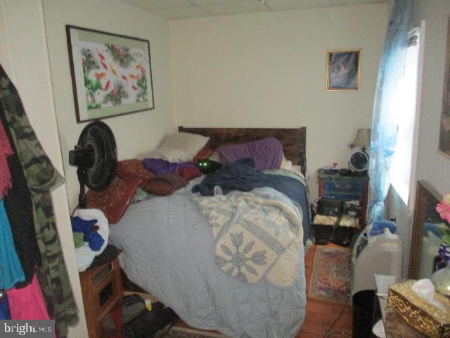 957 Springfield Road Darby, PA 19023 - Photo 13 of 42 a bed with a bed and a painting on the wall