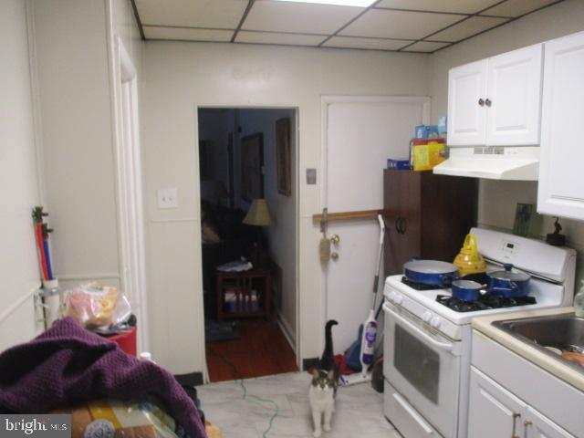 957 Springfield Road Darby, PA 19023 - Photo 15 of 42 a kitchen with a refrigerator and cabinets