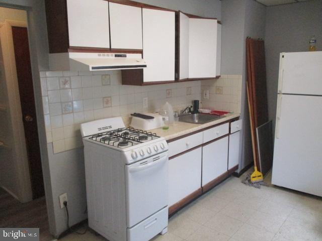 957 Springfield Road Darby, PA 19023 - Photo 32 of 42 a kitchen with stainless steel appliances granite countertop a refrigerator and a stove