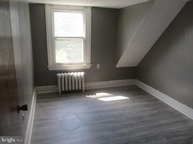 957 Springfield Road Darby, PA 19023 - Photo 35 of 42 an empty room with wooden floor and windows