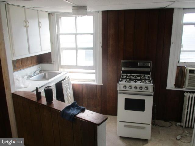957 Springfield Road Darby, PA 19023 - Photo 37 of 42 a kitchen with a refrigerator a stove a sink and a window