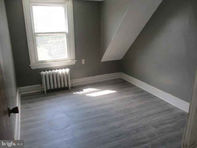 957 Springfield Road Darby, PA 19023 - Photo 39 of 42 an empty room with wooden floor and windows