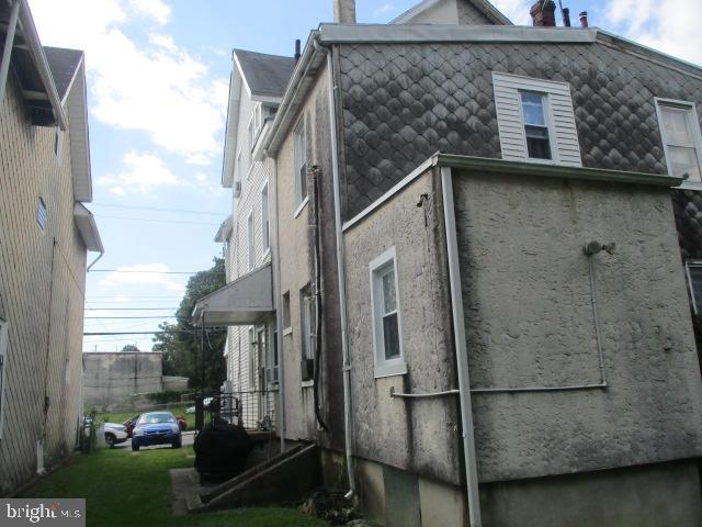 957 Springfield Road Darby, PA 19023 - Photo 4 of 42 a view of a brick house next to a yard