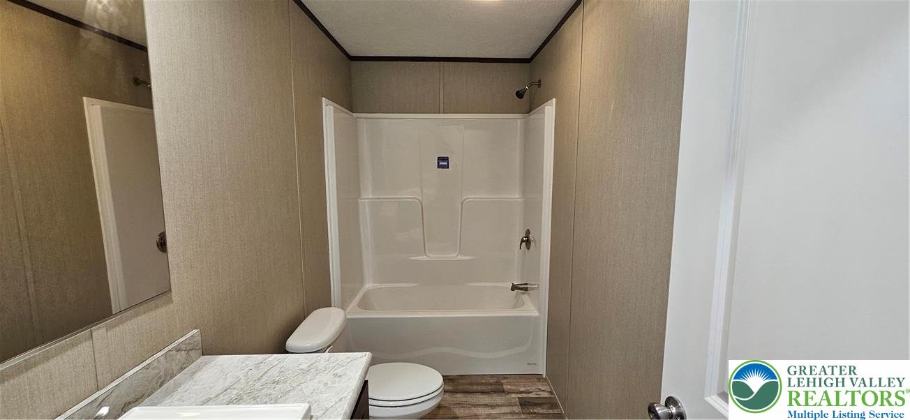 2501 Fox Road Bath, PA 18014 - Photo 9 of 11 a bathroom with a granite countertop toilet a sink and a shower