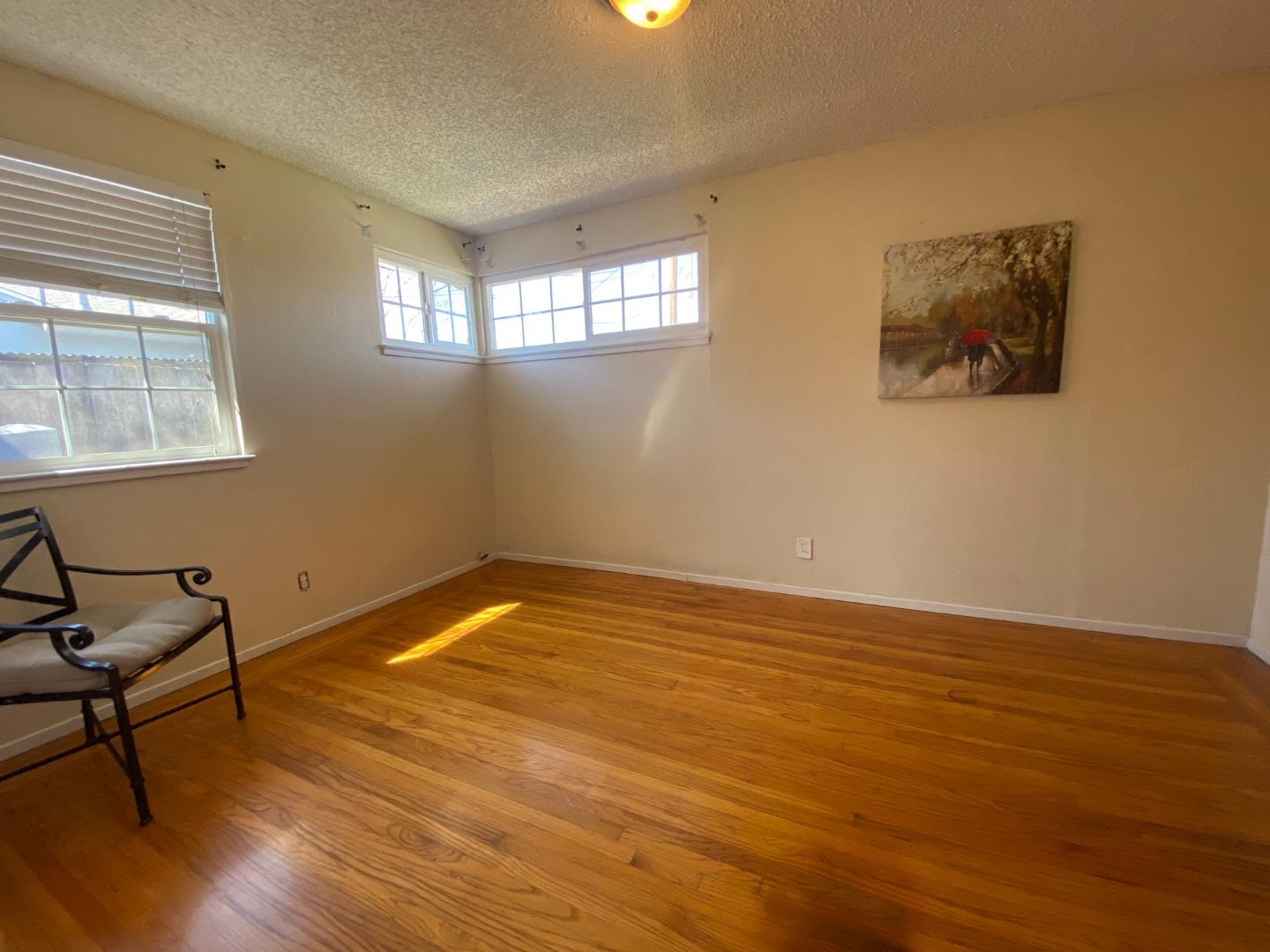 1312 Carleton Drive Concord, CA 94518 - Photo 13 of 16 a view of an empty room with wooden floor and a window