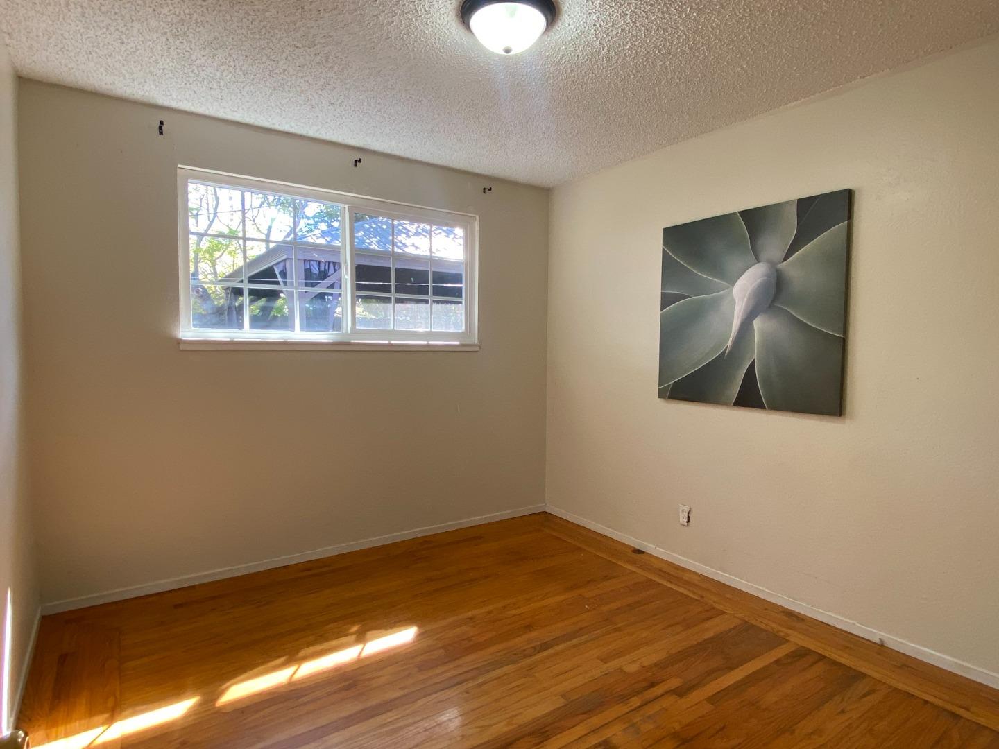1312 Carleton Drive Concord, CA 94518 - Photo 9 of 16 a view of an empty room with wooden floor and a window