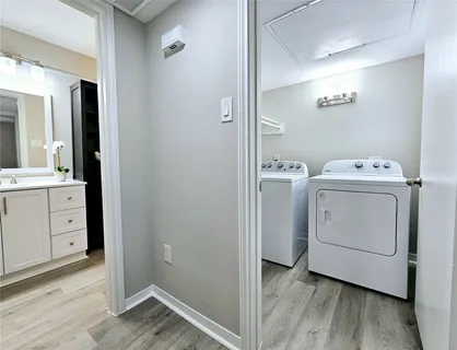 a view of washer and dryer with wooden floor