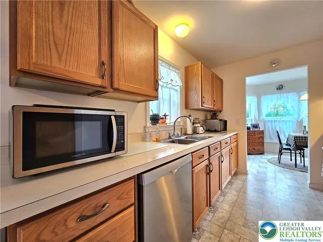 a kitchen with a stove a sink and a refrigerator